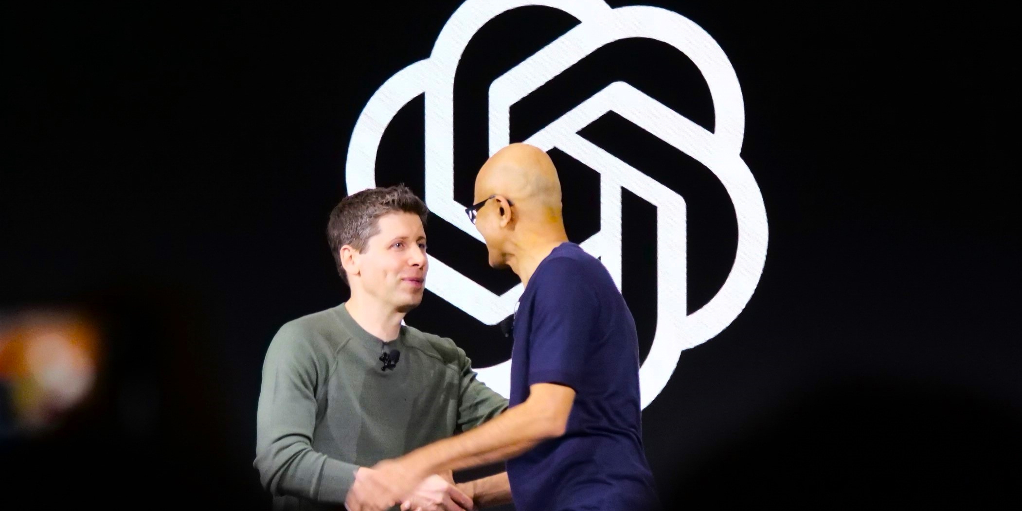 Sam Altman Shaking Hands with Satya Nadella at OpenAI Event after he was ousted from his CEO role but subsequently joined Microsoft